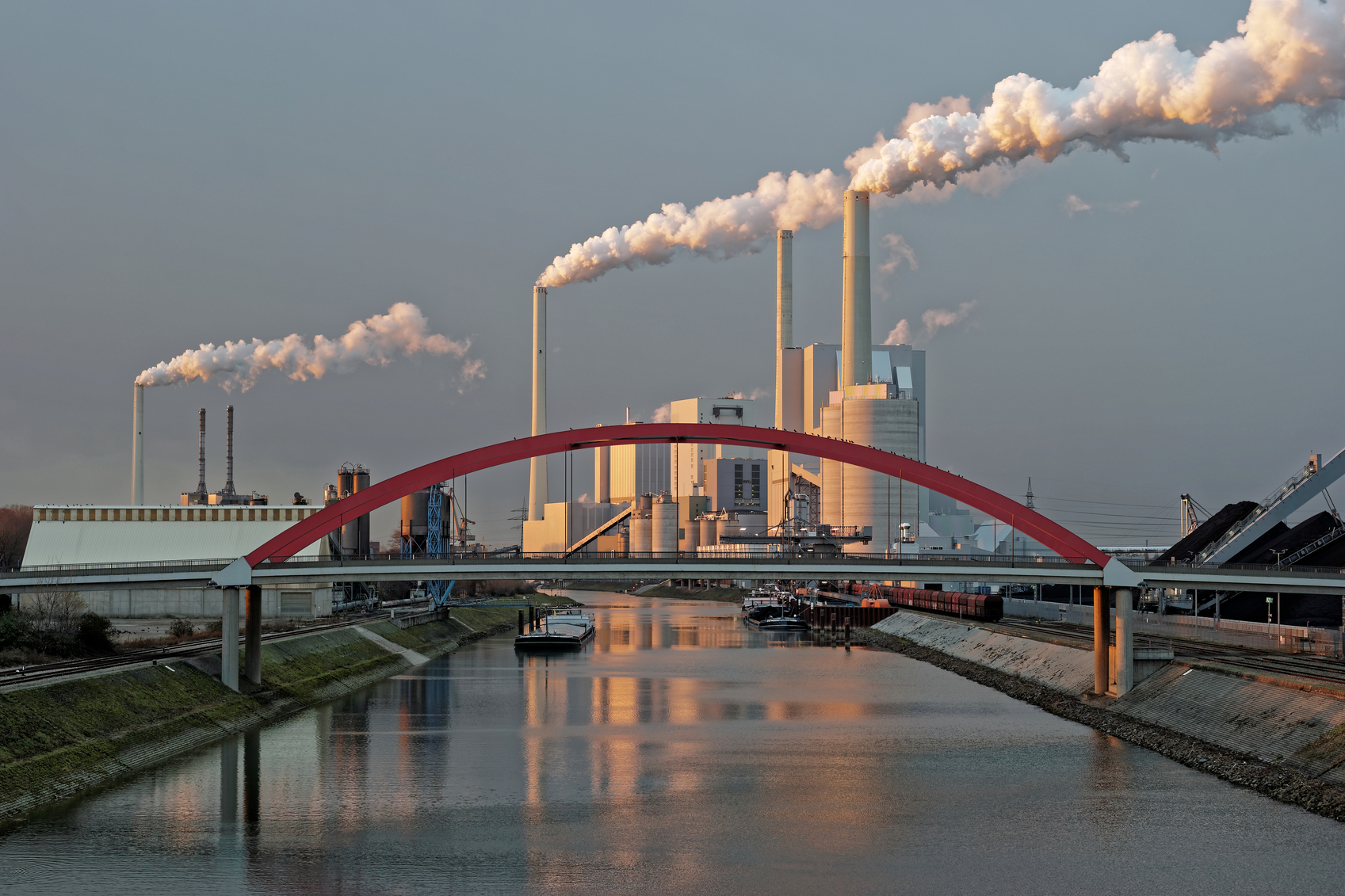 Coal-fired power plant at the shore of the Rhine as seen from a footbridge in Mannheim in Germany.